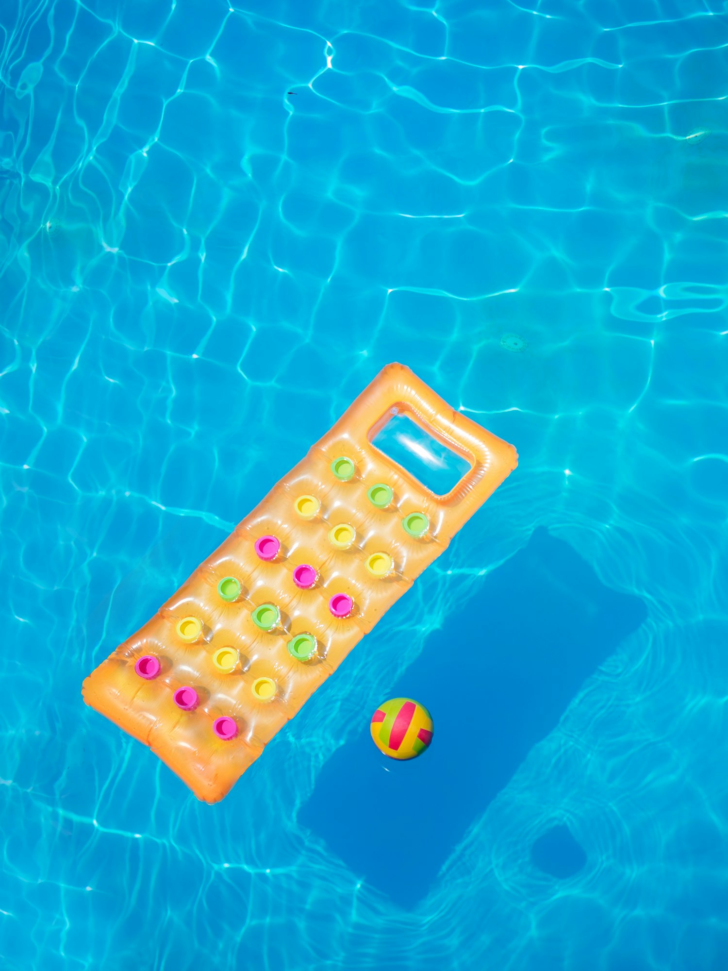 orange air mattress in swimming pool